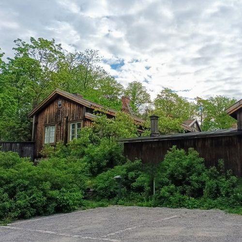 The old wooden houses of Luostarinmäki in a spring landscape.